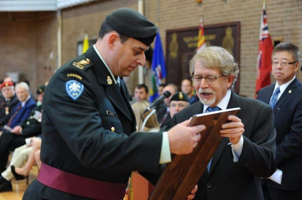 Mayor, Bill Steinberg presents the "Freedom of the City" plaque presented to outgoing Lt. Col. Paul Langlais, during the Change of Command ceremony